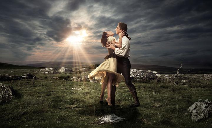 Cathy stands on her toes, reaching to Heathcliff in one of our publicity images