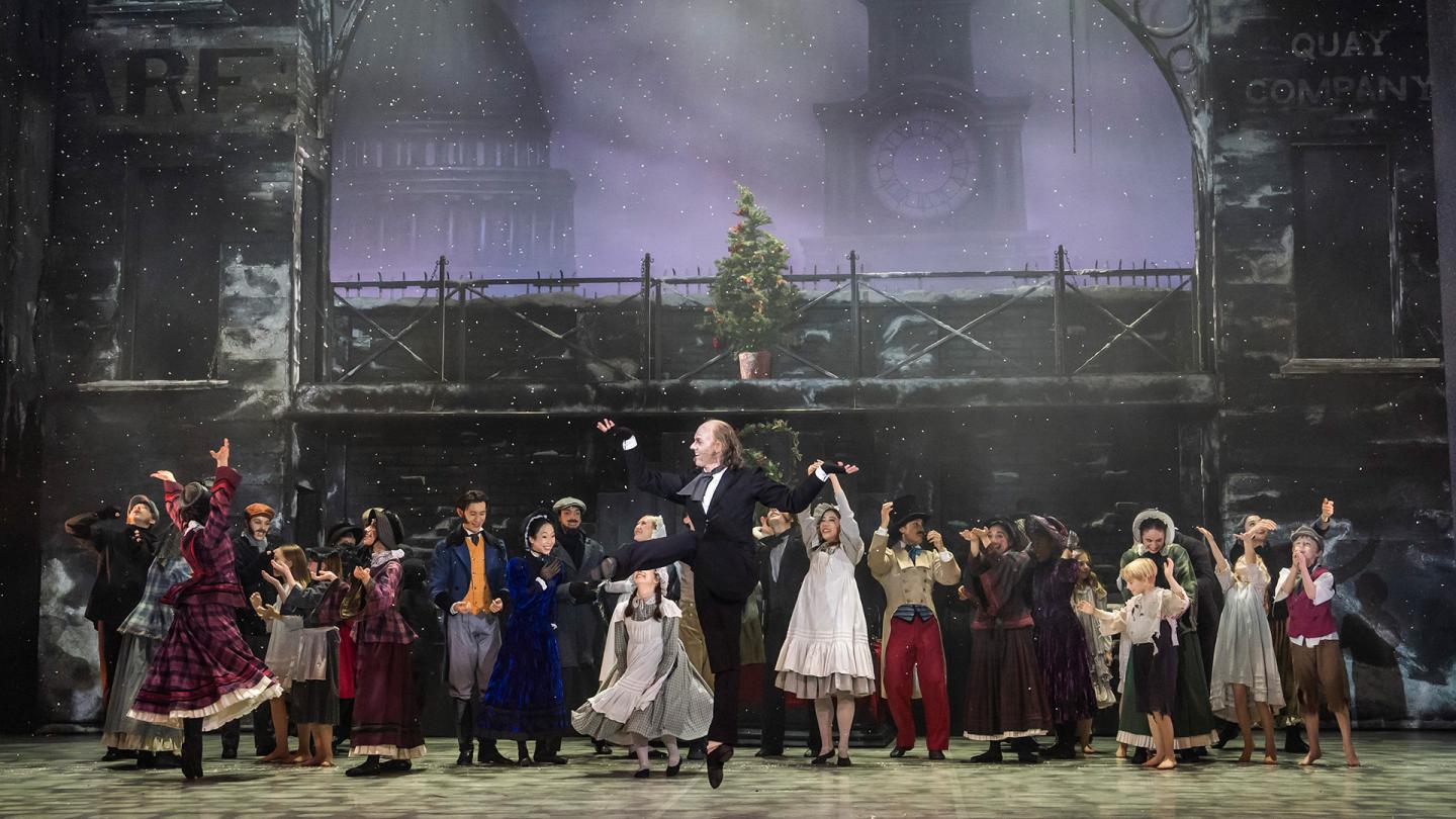 A dancer on stage jumping up in joy