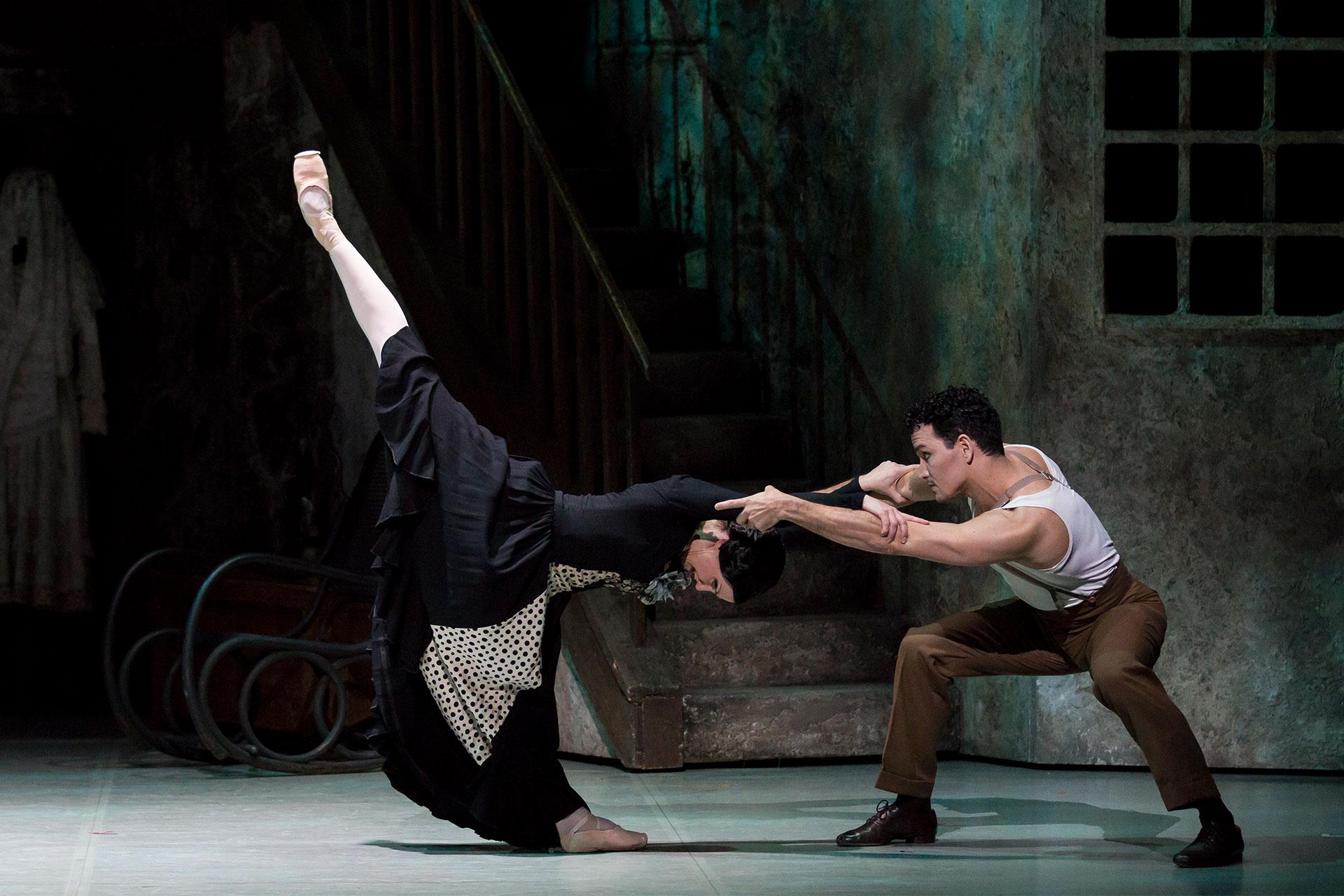 Hannah Bateman leans forward and raises a leg stright up while holding on to Javier Torres with outstretched arms