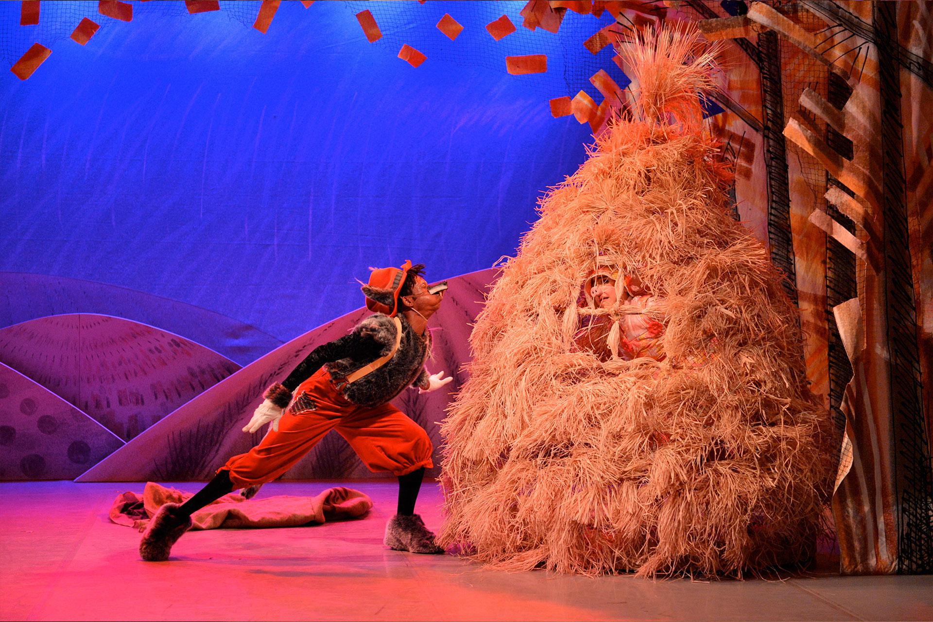 Wolf huffs and puffs the straw house with Straw Pig inside