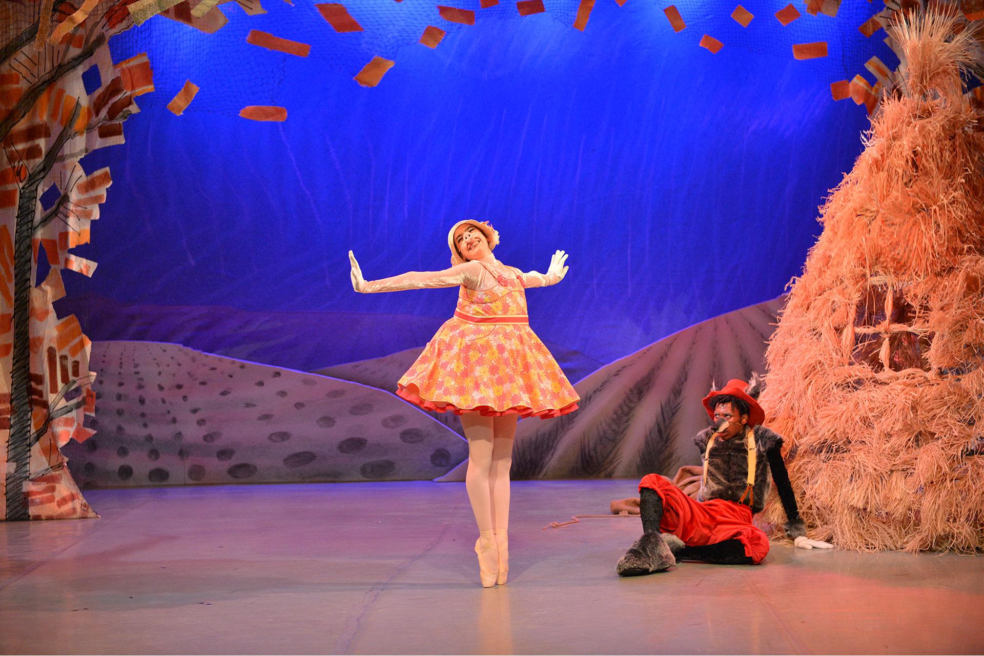 The hungry Wolf looks on as the Pig dances outside her house of straw