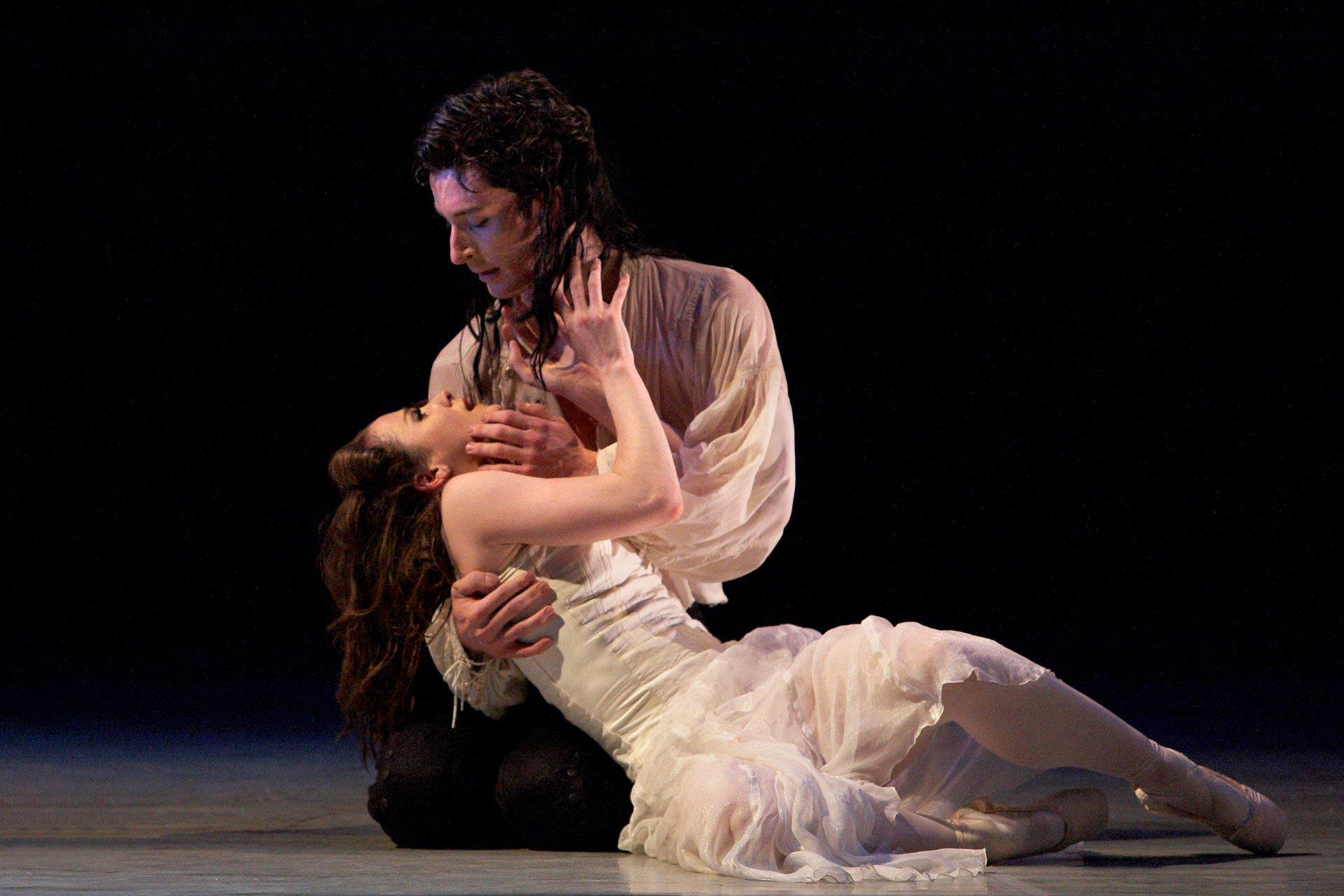 Man holds stricken woman in his arms