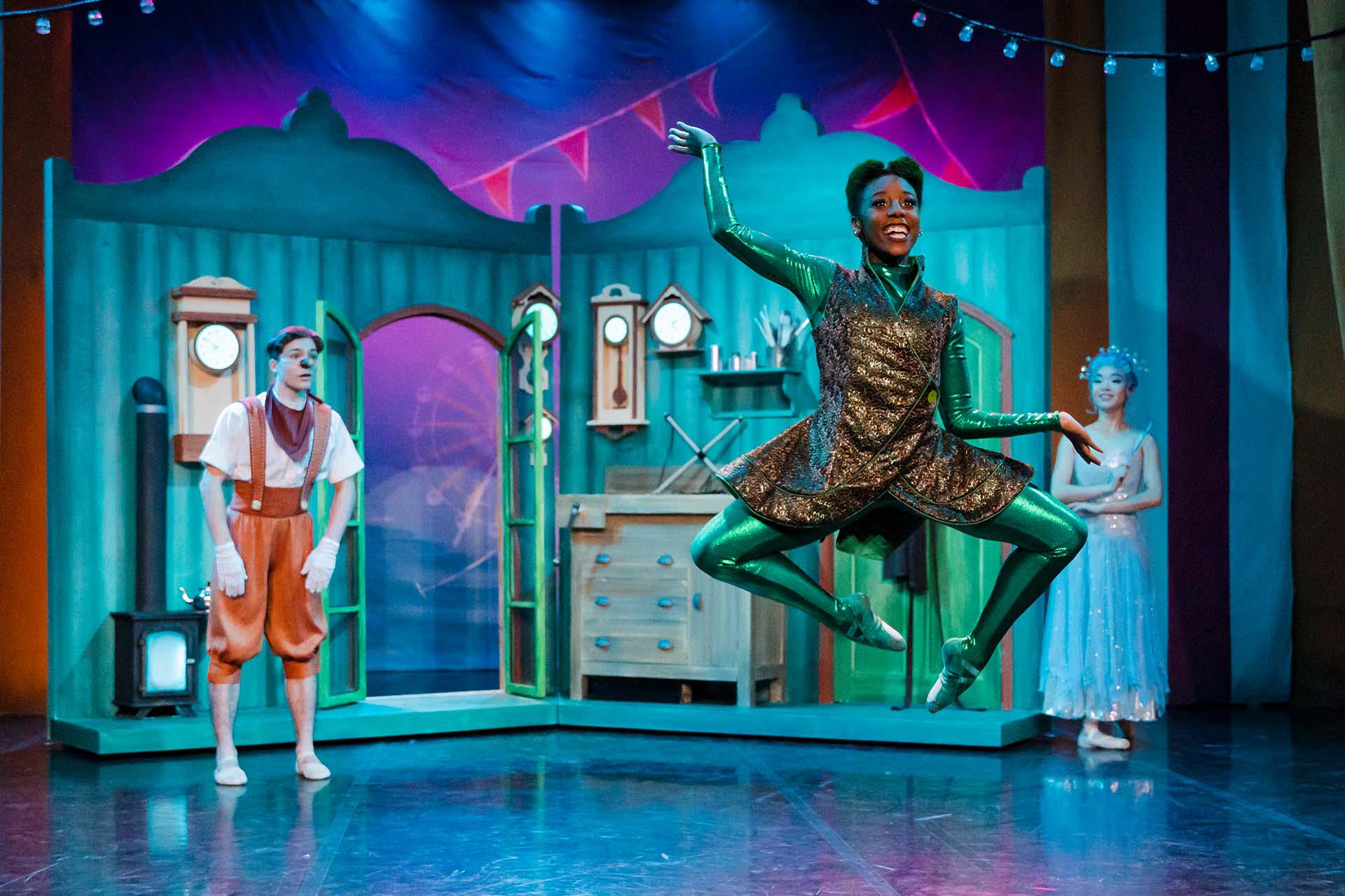 The Water Sprite leaps and dances joyfully while Pinocchio looks on in wonder.