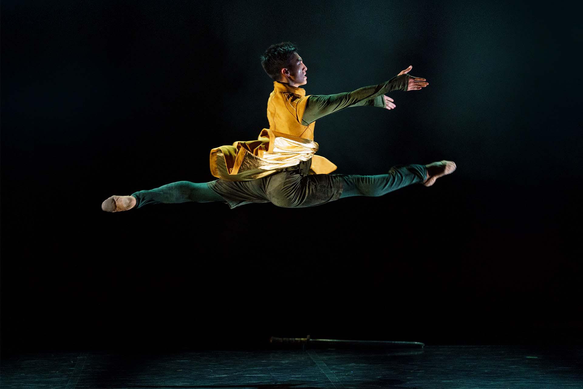 Merlin grand jetes across the stage