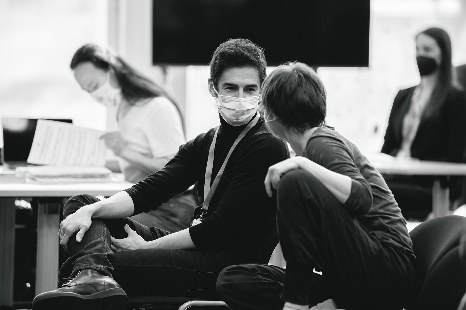 Black and white photo of Federico Bonelli discussing rehearsal with Christelle Horna in the studio