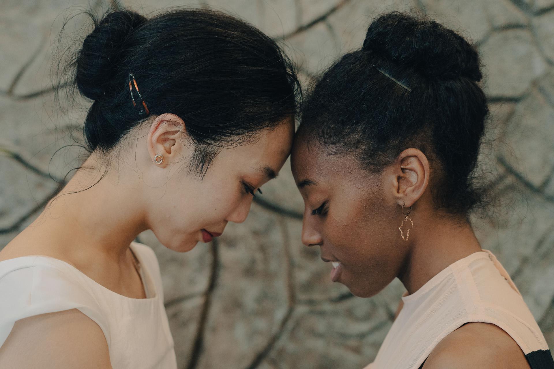 Two dancer close, rest their foreheads against each other while looking down