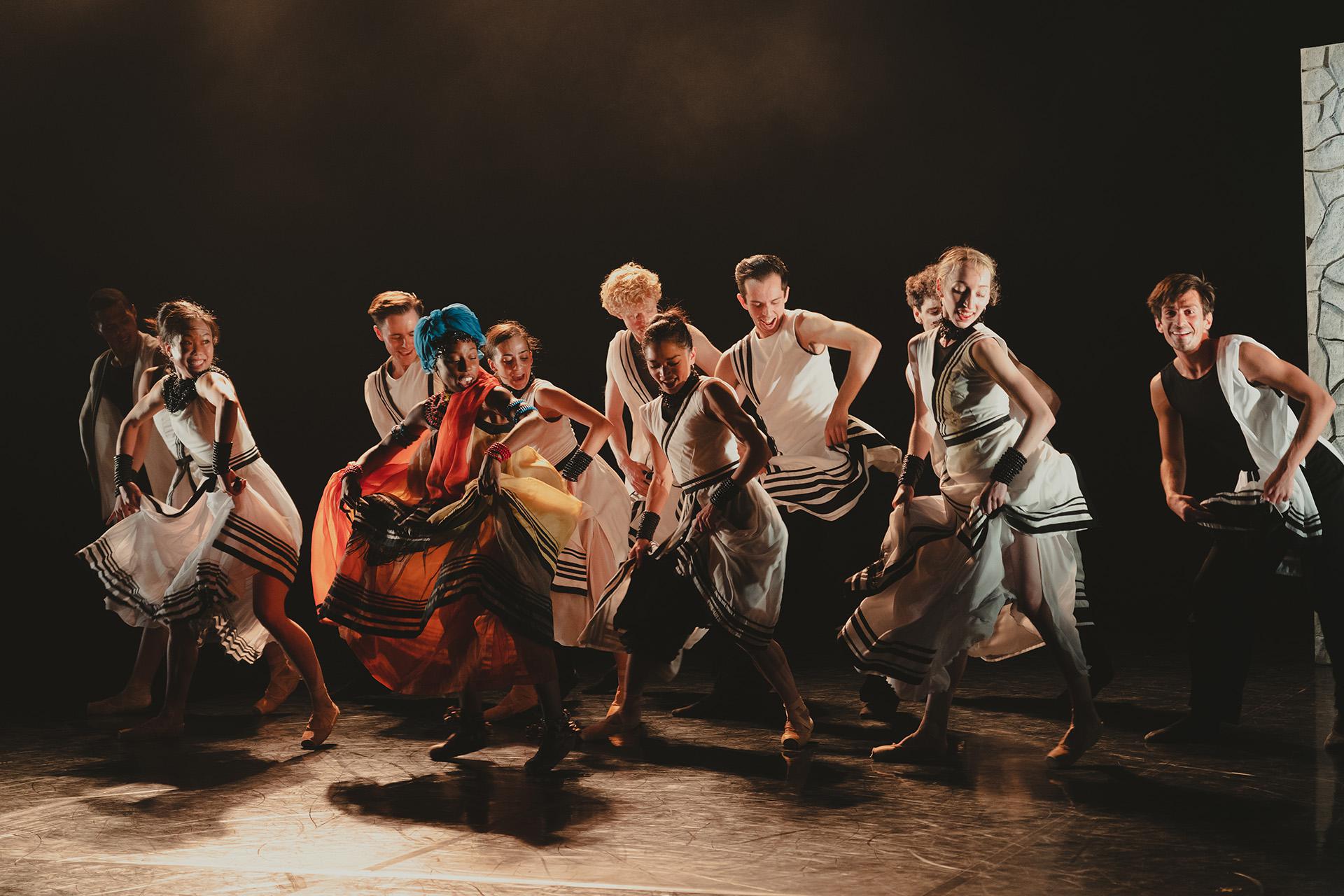 Dancers perform celebratory in unison