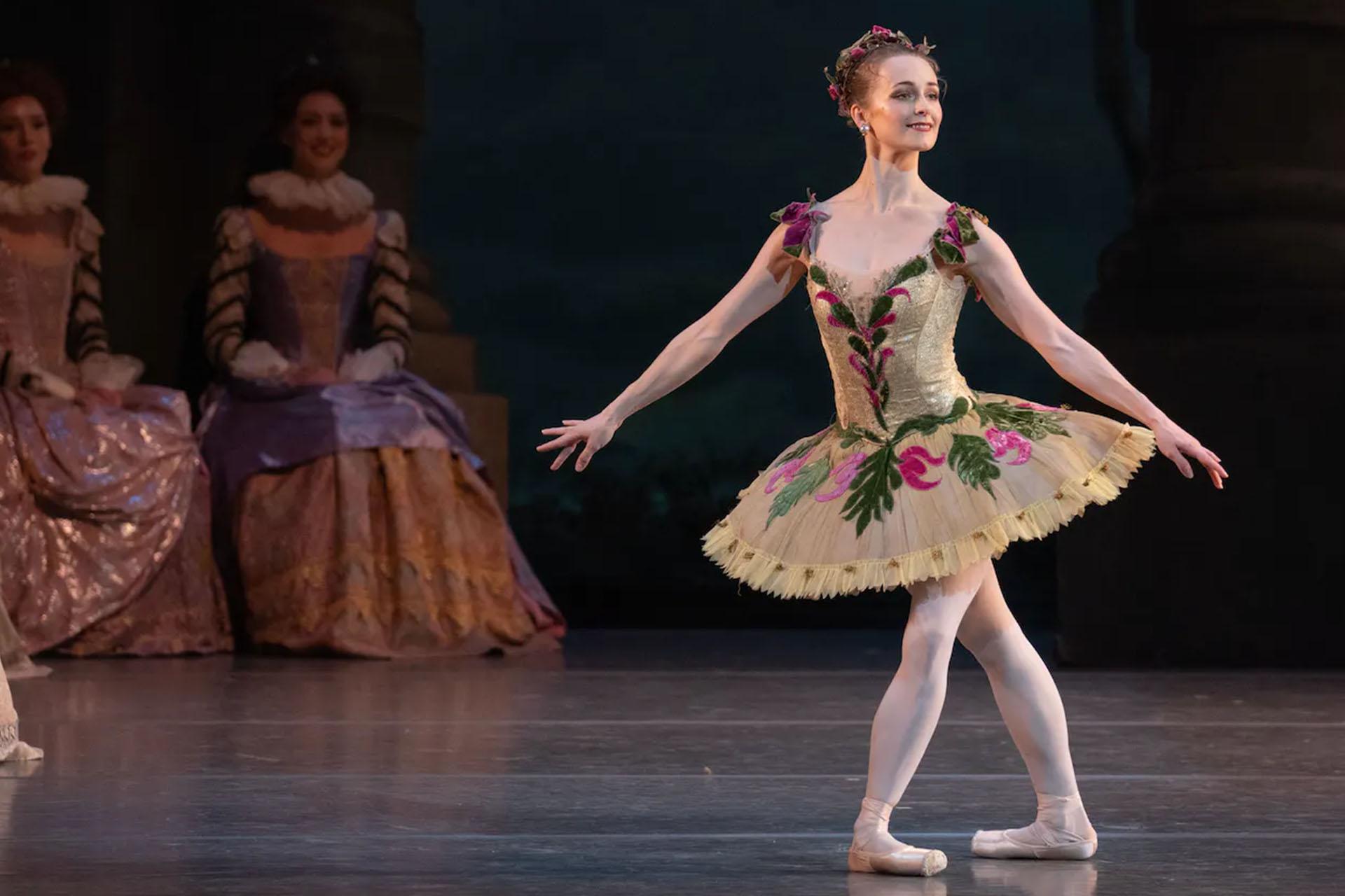 Photo of a female dancer in a classical ballet pose wearing a tutu performing as one of the fairies in the sleeping beauty