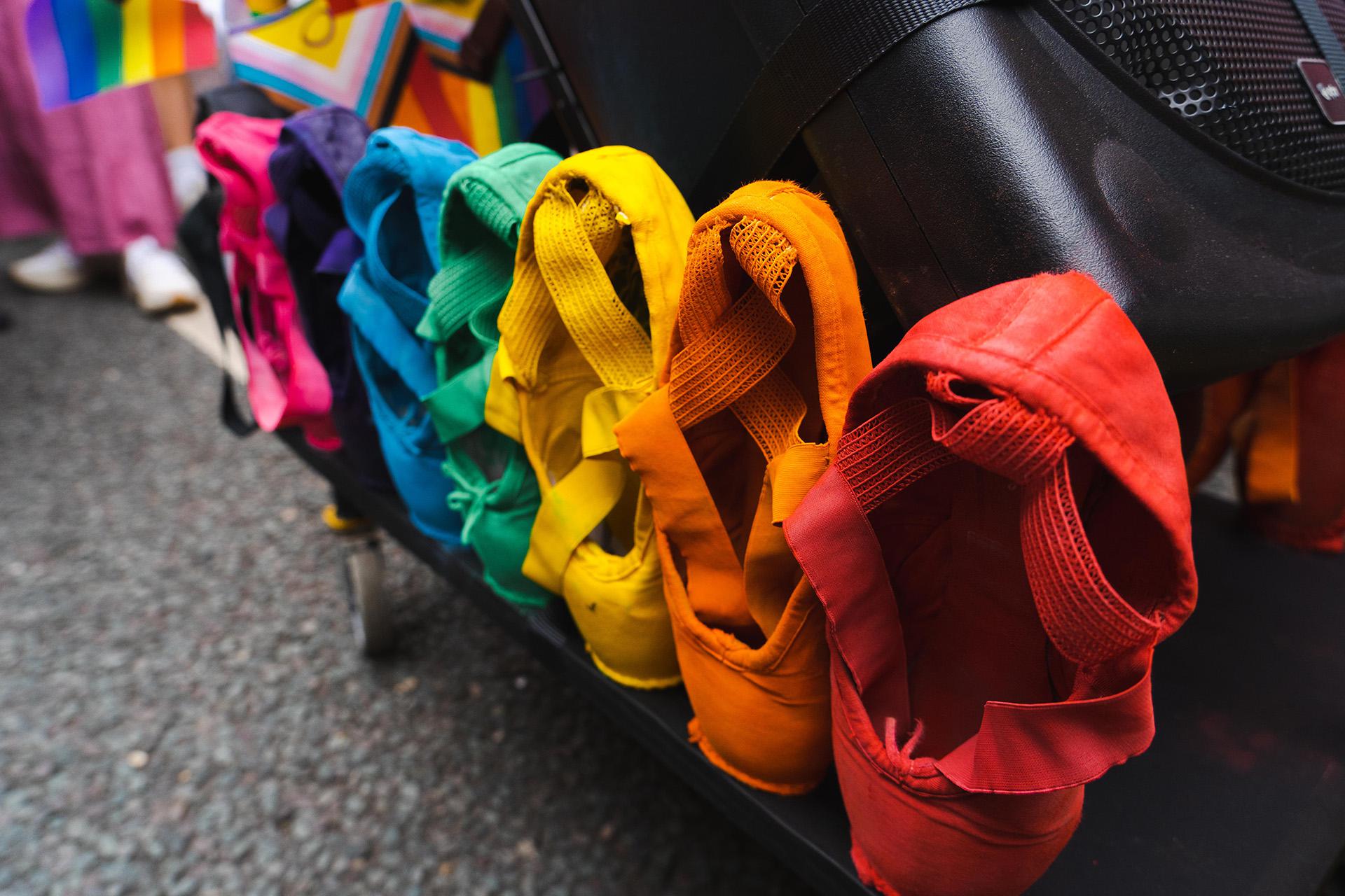 Eight pointe shoes, each dyed a different colour to celebrate Pride in Leeds