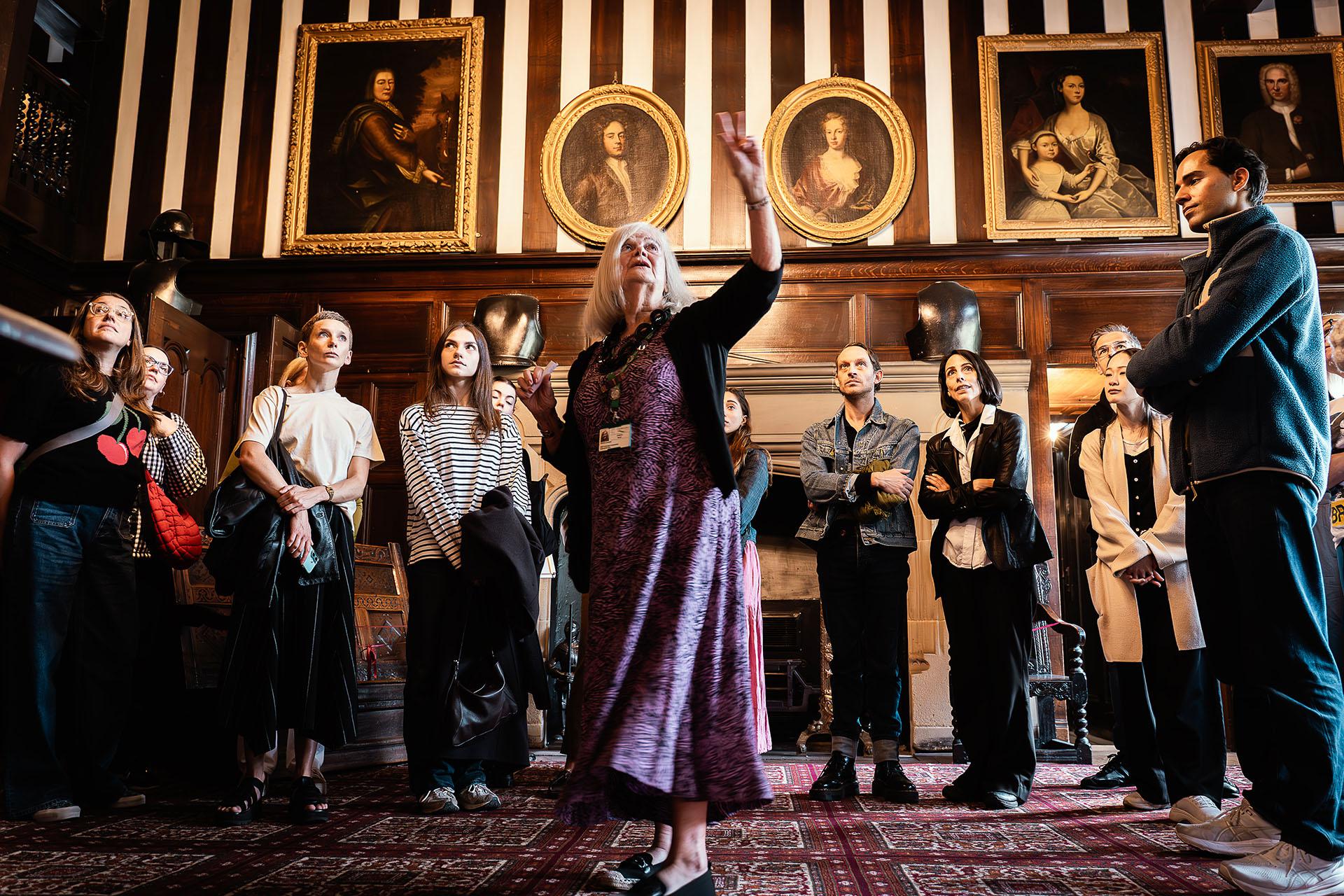 Northern Ballet dancers and Gentleman Jack creatives inside Shibden Hall listening to a historian.