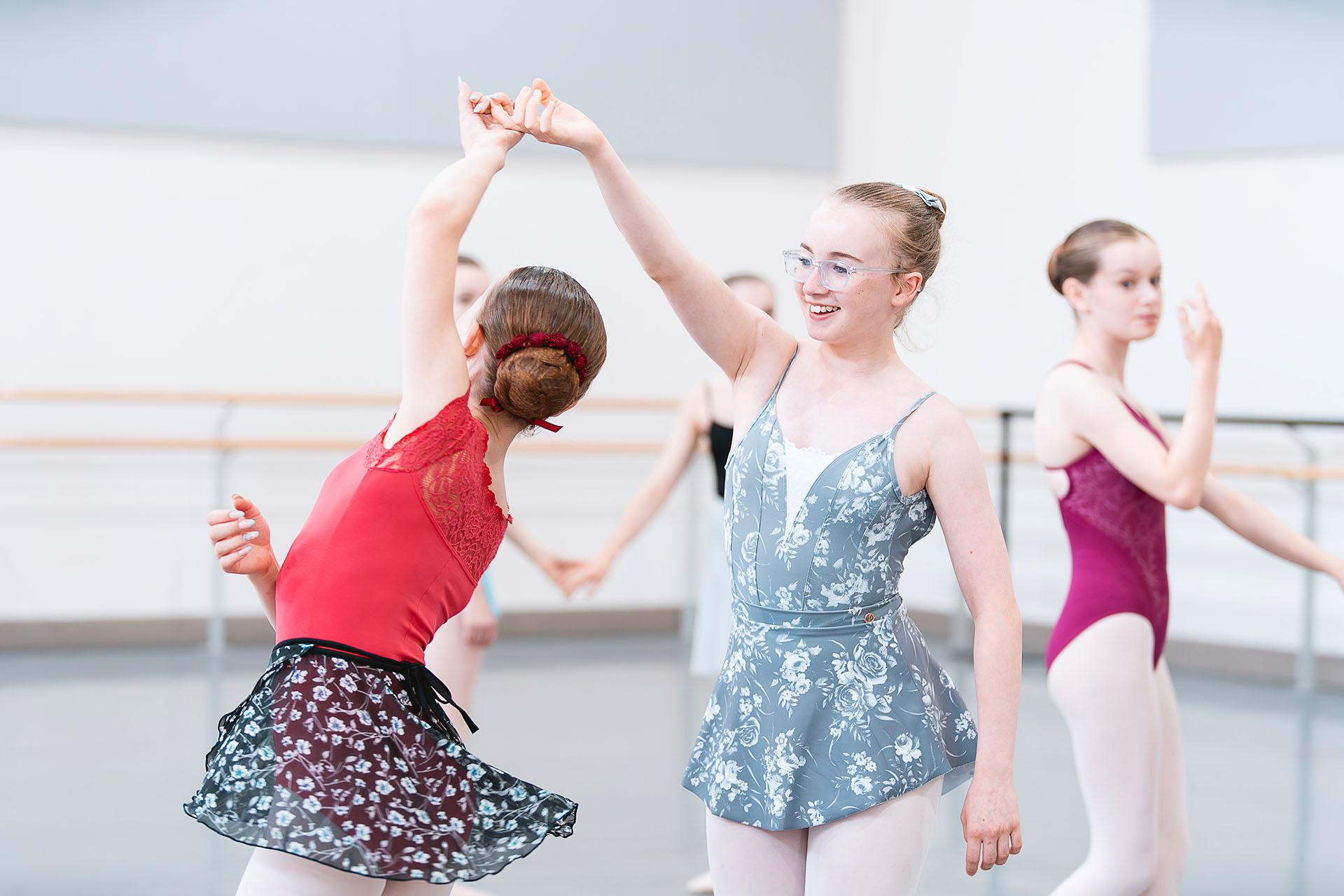 Young dancers in training, one twirling another