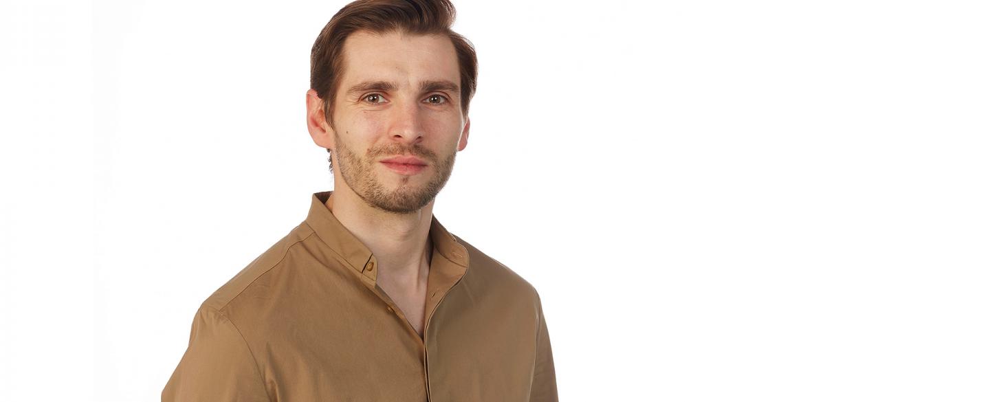 Publicity photo of dancer Ashley Dixon in a tan shirt