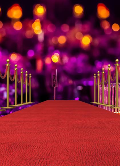 A red carpet bounded by gold coloured stanchions.