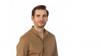 Publicity photo of dancer Ashley Dixon in a tan shirt