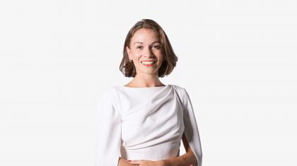 Headshot of a female dancer with short brown hair in a white dress