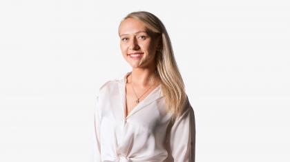 Headshot of a female dancer in a white shirt