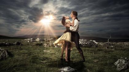 Cathy stands on her toes, reaching to Heathcliff in one of our publicity images
